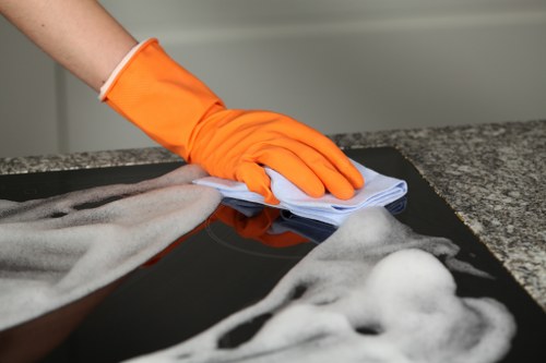 Homeowner using baking soda for oven cleaning